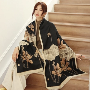 Close-up of thick cashmere-like scarf showing lotus pattern and soft fringe tassels