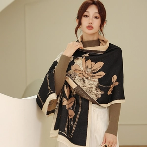 Detail of cashmere-like shawl featuring lotus floral pattern in black and beige contrast