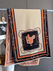Détail de l'imprimé selle et chaîne sur un châle beige épais en cachemire avec franges