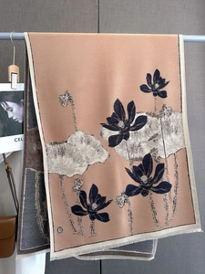 Close-up of mustard green and beige scarf with ink lotus patterns and fringe edge