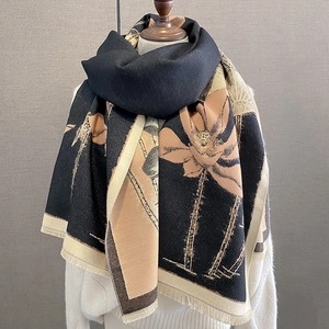Detail of floral shawl with beige and black panels and soft tassel edges