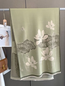 Close-up of mustard green scarf with lotus jacquard pattern and fine fringed edges