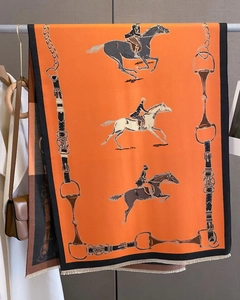 Detail of equestrian cashmere feel scarf featuring orange horse and harness patterns