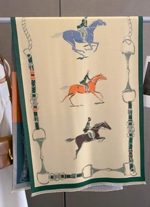 Detailed view of beige cashmere-feel scarf featuring vintage equestrian horse prints and fringes