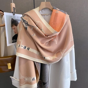 Detail of peach pink horse-drawn carriage print on soft cashmere-like shawl wrap