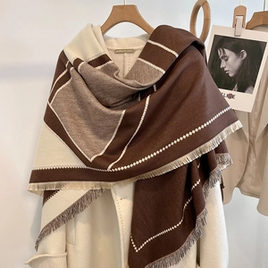 Detail view of winter color-block thick shawl with geometric texture and tassels