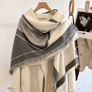 Fashionable grey and white color-block cashmere scarf with fringe on beige coat