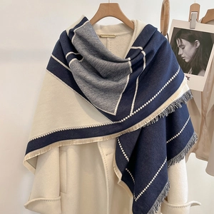 Navy blue and beige color-block cashmere scarf with fringe on a wool coat