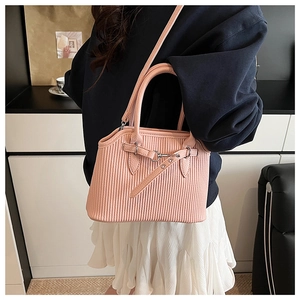 Pink ribbed tote bag detail featuring silver buckle strap and round handles with shoulder strap