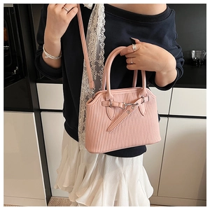 Detail showing pink pleated texture and silver buckle on large shell tote bag