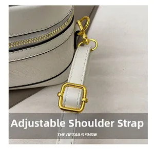 Detail of adjustable leather strap with premium gold-tone metal buckle and texture