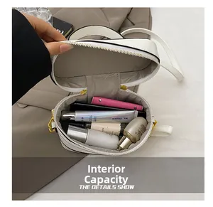 Interior view of small white box bag showing storage space for makeup and skincare