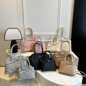 Retro pleated tote and shell bags in five colors displayed on elegant white steps
