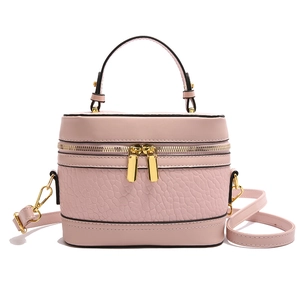 Pink minimalist box handbag in textured leather with top handle and gold zipper