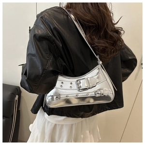 Silver mirror Y2K shoulder bag with metal rivet details and buckle straps shown on model