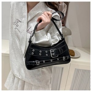Detailed view of black Y2K shoulder bag with silver eyelets and buckle straps decoration