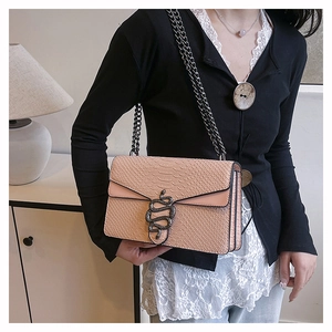 Close-up of pink snakeskin pattern bag with black metal snake buckle and chain strap