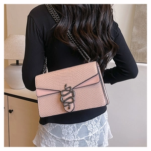Close-up of pink snakeskin pattern shoulder bag with vintage metal snake buckle