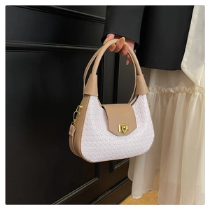 Detailed close-up of woven texture and gold square twist lock on chic beige shoulder bag