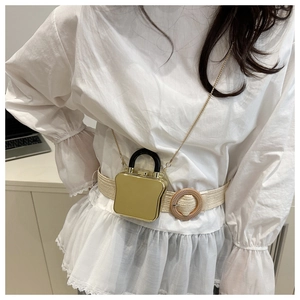 Mini goldene Toast-Tasche mit Kettenriemen am Model für kleine Accessoires präsentiert