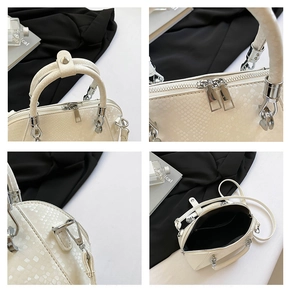 Detailed views of beige snakeskin textured handbag with silver zippers and elegant handles