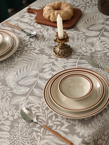 Detailed texture of thick waterproof linen tablecloth with beige floral leaf patterns