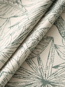 Macro detail of thick linen tablecloth with tropical green palm leaf patterns