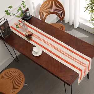 Minimalist cotton linen table runner with orange geometric patterns and handmade tassels