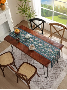 Detail of floral waterproof table runner on a dark wood table in a modern living room
