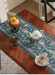 Detailed close-up of floral table runner on dark wood table in home dining setting
