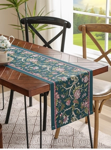 Close-up of dark green waterproof table runner with elegant floral pattern on wood table