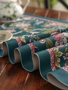 Close-up of waterproof table runner with floral print and thick leather-like texture