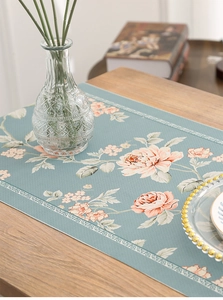 Close-up of floral waterproof table runner with pink peonies and vintage lace border
