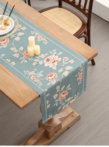Detail of floral table runner with pink roses on morandi blue thick waterproof fabric