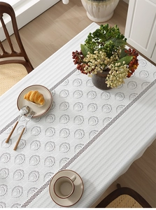Macro detail of French jacquard lace tablecloth with circular cutouts and polka dot borders