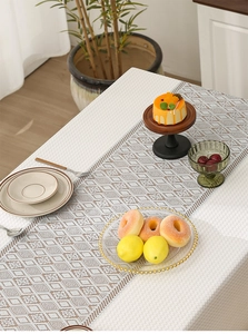 Detailed view of cream waffle fabric tablecloth with vintage brown lace hollow pattern