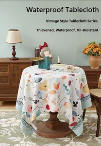 Detail of round thick cotton linen tablecloth with floral pattern and waterproof coating