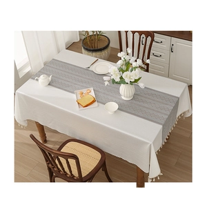 White jacquard tablecloth with fringe and gray geometric runner set for dining table