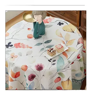 Detail view of round thick linen tablecloth with colorful watercolor floral patterns