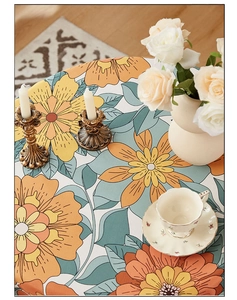 Detailed top view of retro floral round tablecloth with elegant orange and green floral patterns