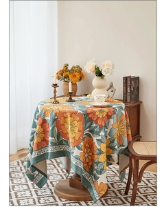 Detail of round waterproof tablecloth with vintage floral print on a small wooden table