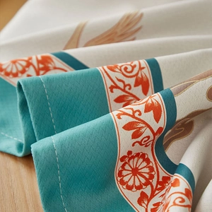 Detail of thickened cotton linen tablecloth with vintage floral prints and blue borders