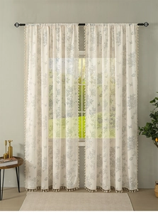 Detail of semi-sheer floral curtain with butterfly print and white tassel fringe