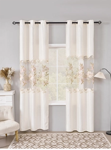 Detailed embroidery on off-white curtains with floral patterns and sheer lace texture