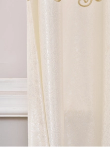 Close-up of European cream curtains with floral jacquard and gold silk embroidery detail