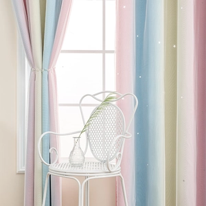 Detail of double-layer rainbow curtains with laser-cut hollow stars and soft tulle layer
