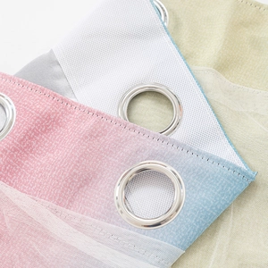 Detail of double-layer hollow star curtains with silver grommets and airy white mesh overlay