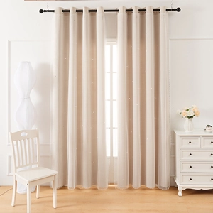 Detail of double-layer blackout curtain with laser cut stars and white lace overlay