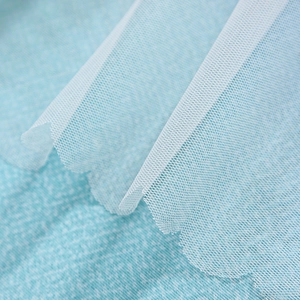 Detailed close-up of double-layer curtain with white hexagonal mesh and wavy lace edges