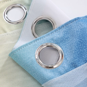 Close-up of silver grommets and gradient blue-green fabric texture on kids curtains